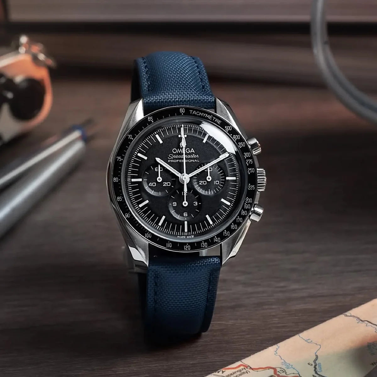 Luxury watch with blue strap on a wooden surface
