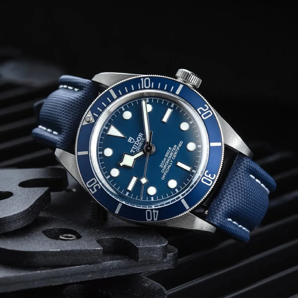 Blue watch with a detailed face on a dark background