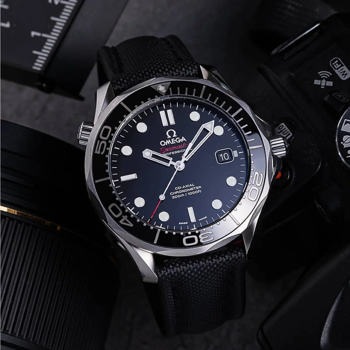 Omega watch with black strap and blue dial on a dark background
