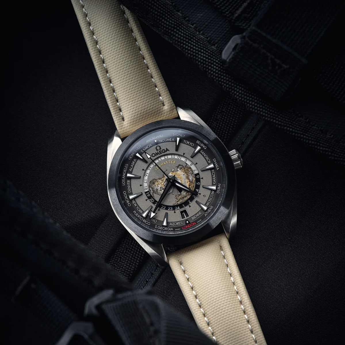 Omega watch with beige strap on a dark background