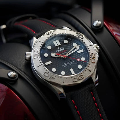 Omega watch with black dial and red accents on a dark background