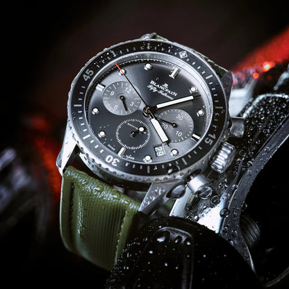 Luxury watch with a green strap on a dark background