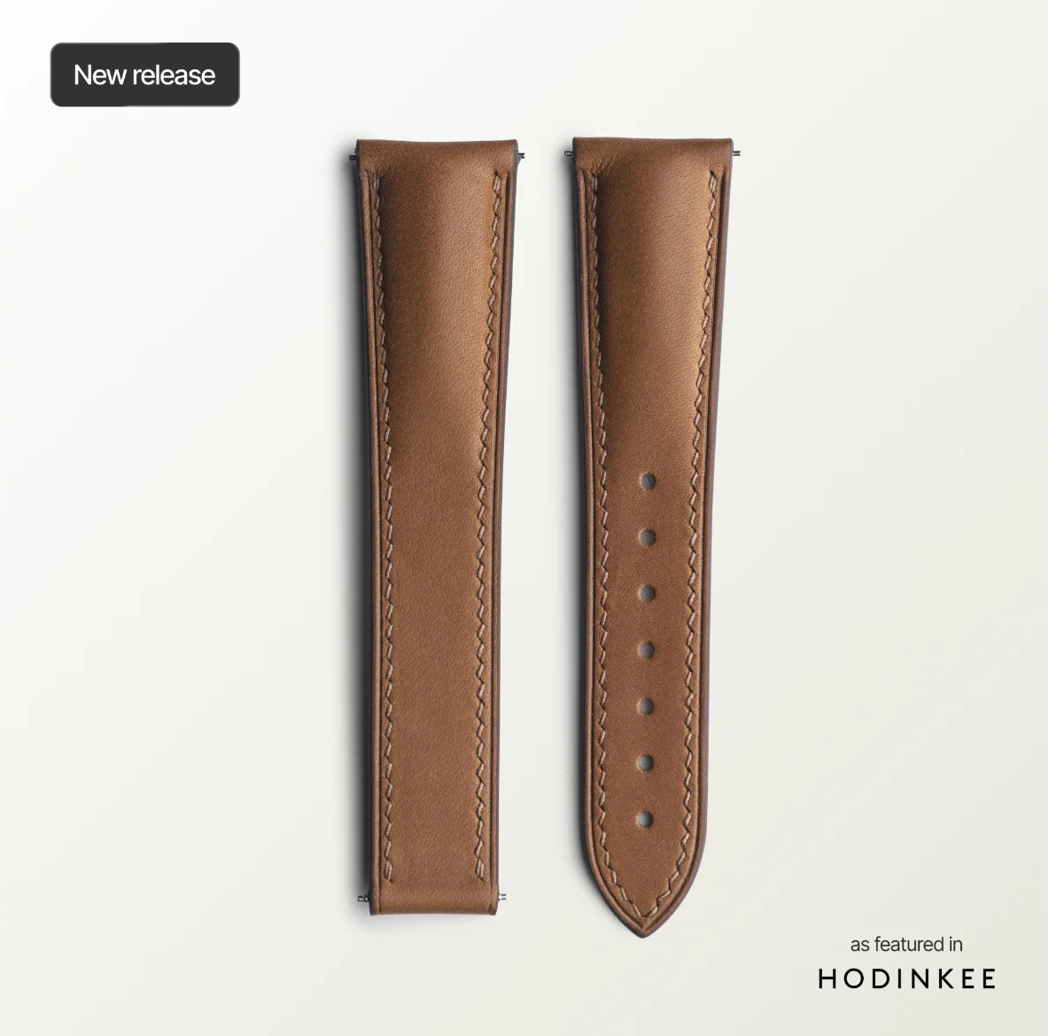 Brown leather watch strap on a light gray background with 'Hodinkee' branding.