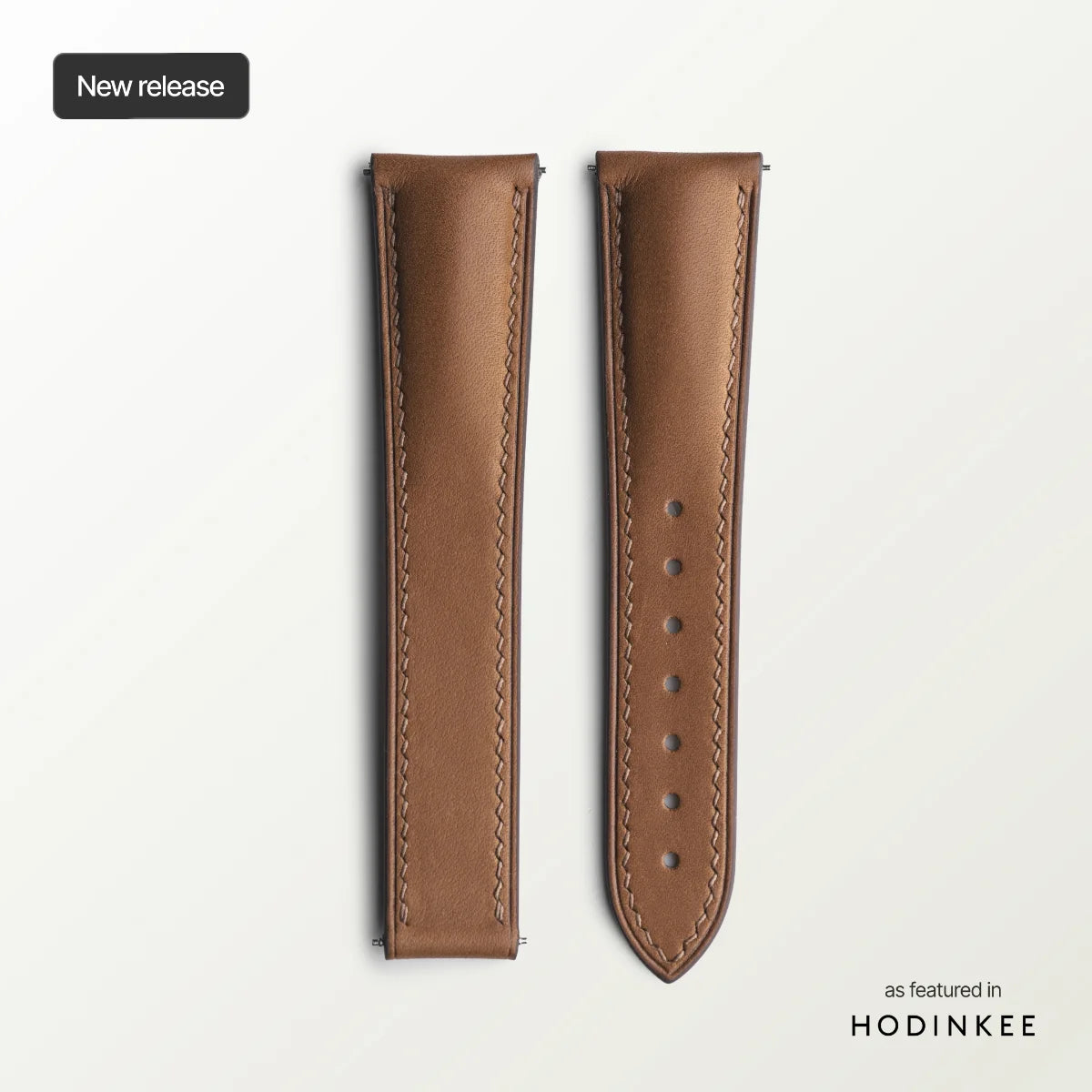 Brown leather watch strap on a light gray background with 'Hodinkee' branding.