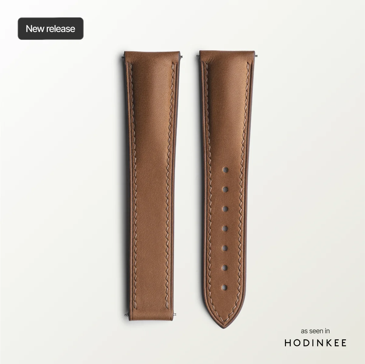 Brown leather watch strap on a light gray background with 'Hodinkee' branding.